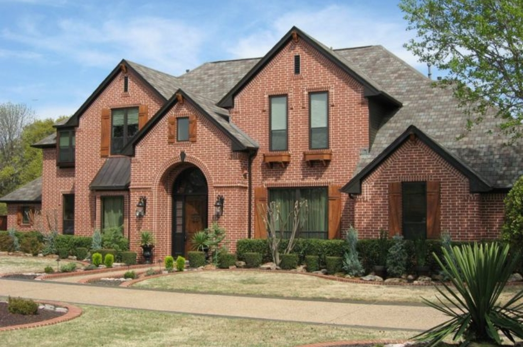 A beautiful, modern home in a neighborhood like The Woodlands, with sunlight gleaming off crystal-clear windows.