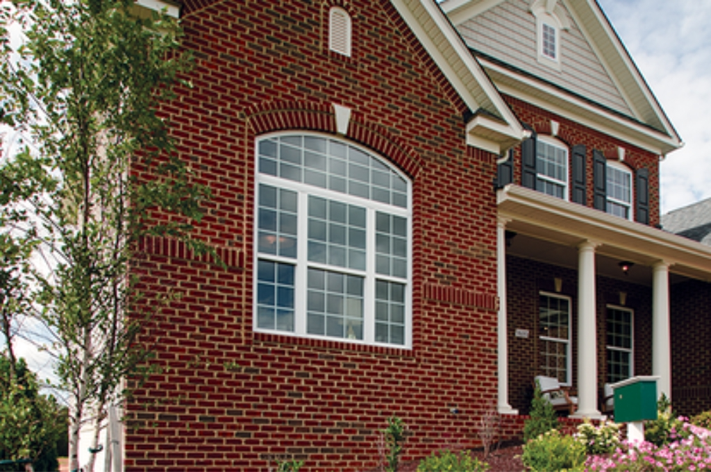 A family-style home in a community like Sugar Land, with a focus on the clean, clear windows.