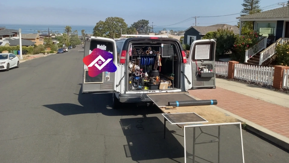 Close-up of a technician using a spline roller to install a new window screen during a mobile repair visit in a Texas home