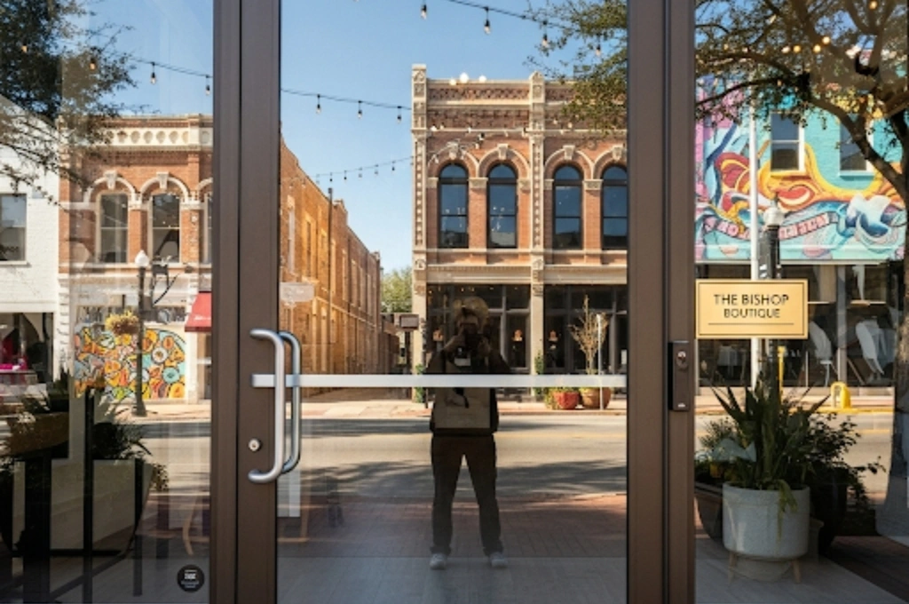 A clean, secure glass storefront door for a retail boutique in the Bishop Arts District of Dallas.