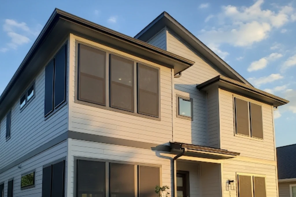 Sleek, dark solar screens installed on a modern Mueller home in Austin, effectively reducing sun glare.