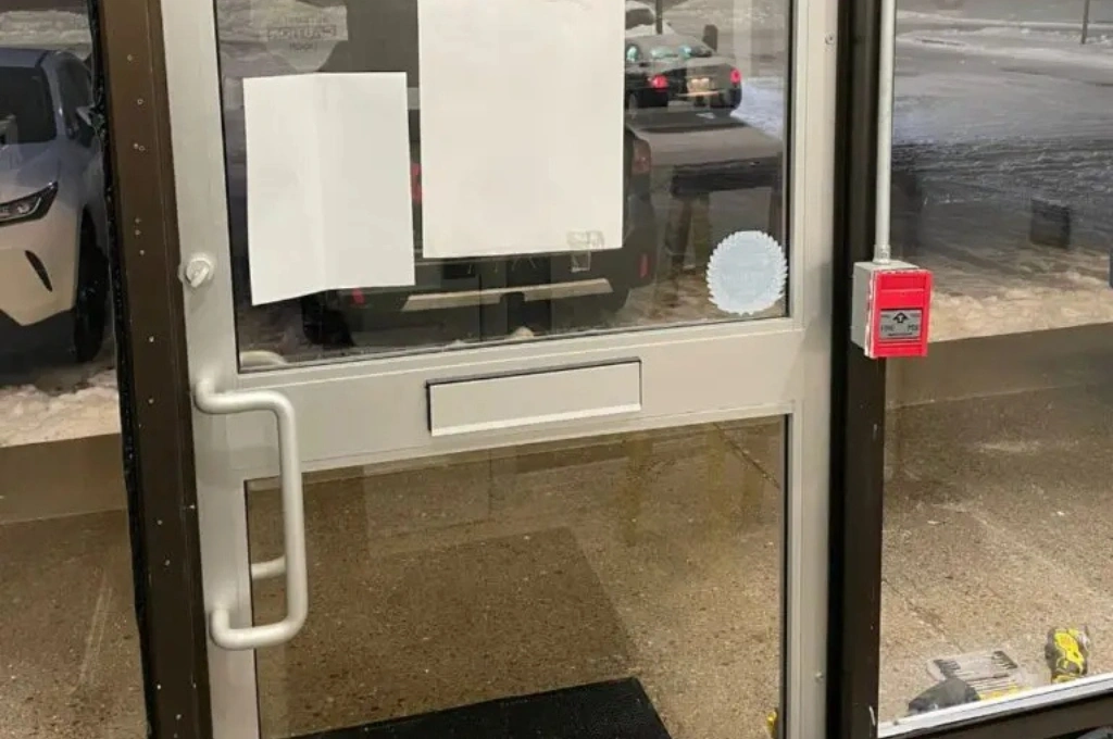A Windows And Doors Repair LLC technician performing a rapid commercial glass door repair for a business in Garland, ensuring smooth operation and customer access.