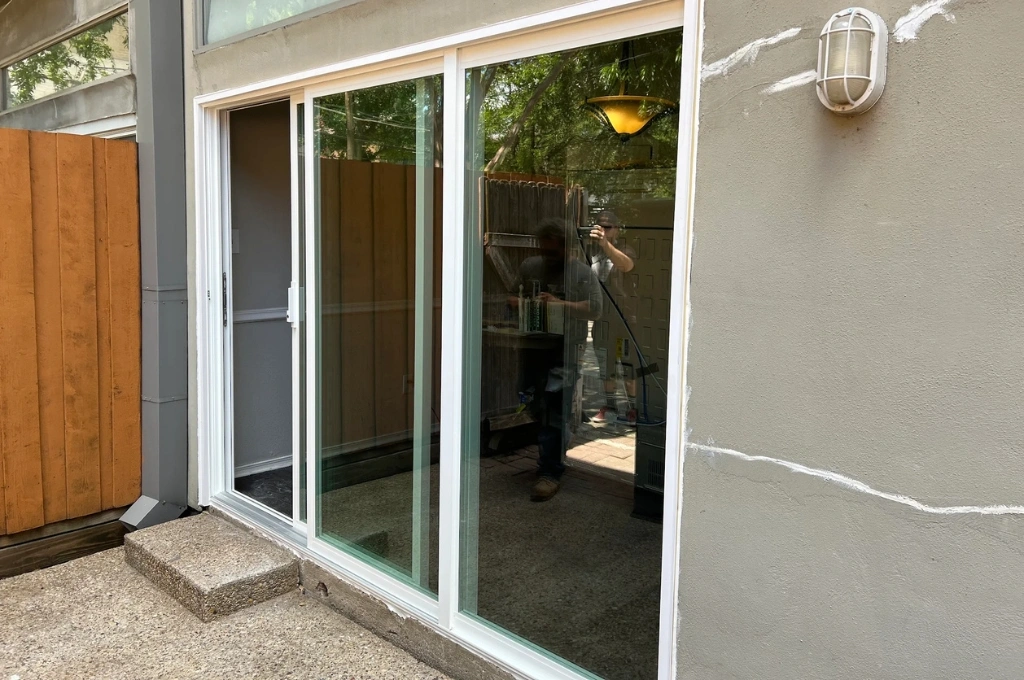A perfectly repaired sliding glass door in Arlington, TX, gliding smoothly on a new track.