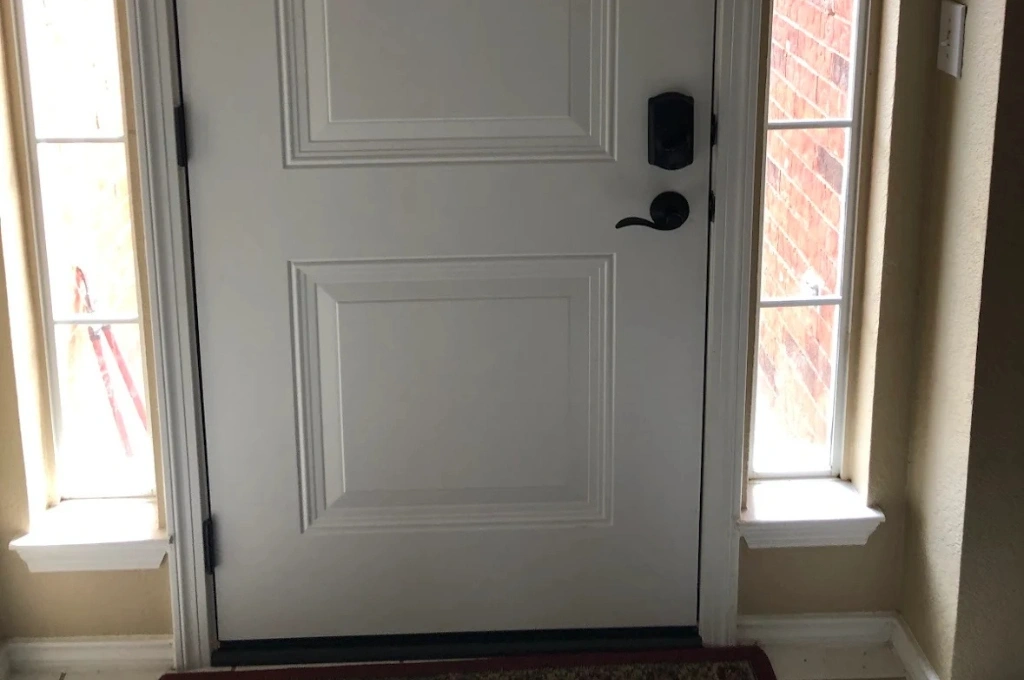 A secure front door after door frame repair and weatherstripping replacement in Arlington.