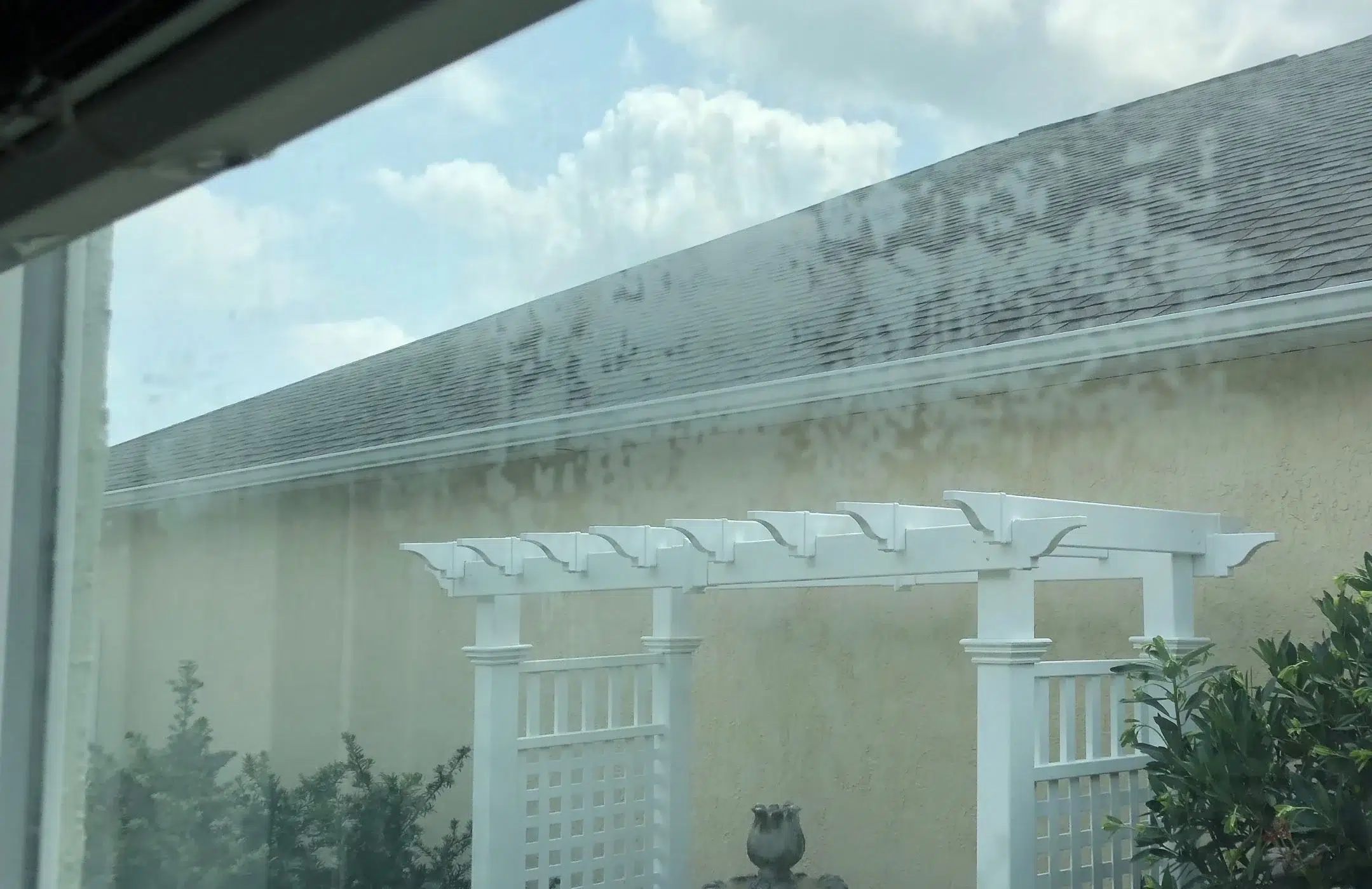Foggy double pane window glass showing failed thermal seal and desiccant saturation in an El Paso Texas residence