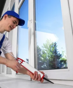 A close-up of your technician's hands expertly performing a professional window seal repair.