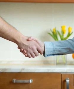 A friendly technician in a company shirt smiling.