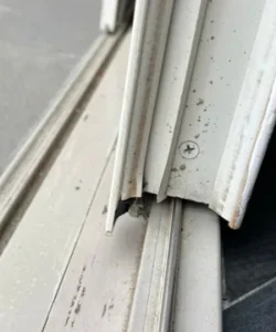 A frustrating shot of a sliding door stuck off its track.