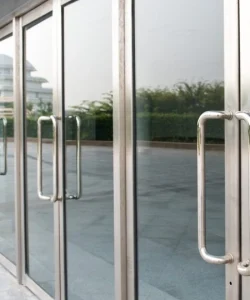 A sleek, modern commercial glass storefront door.