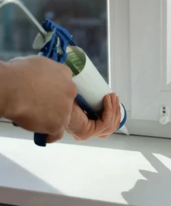 A technician performing an expert window seal repair in Garland, TX, showcasing the brand's skilled craftsmanship.