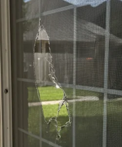 A typical damaged window screen that needs repair in a Houston home