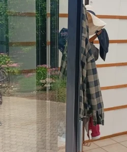 A uniformed technician with your logo, smiling and shaking hands with a happy homeowner in a Dallas-style brick home.