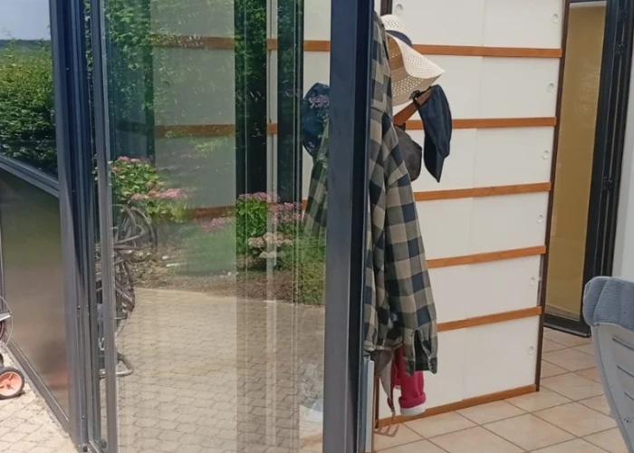 A uniformed technician with your logo, smiling and shaking hands with a happy homeowner in a Dallas-style brick home.