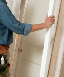 An expert technician from Windows And Doors Repair LLC performing a precise door repair in the Fort Worth area.