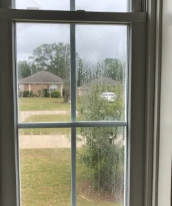 Foggy double-pane window glass in a dallas home needing professional repair.