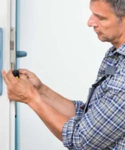 Professional technician performing an expert door repair on a beautiful stucco home in San Antonio.
